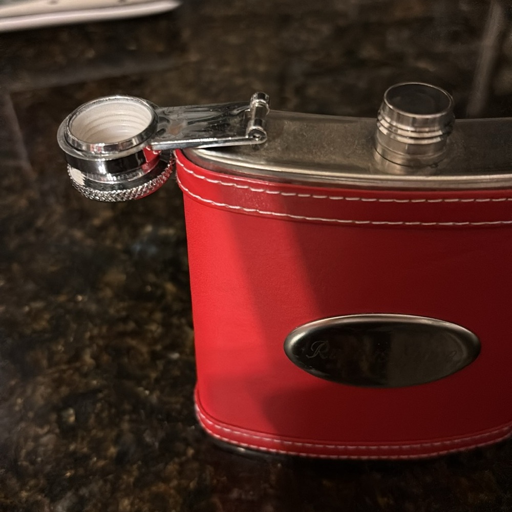 Small Red Flask w/Silver Accents Reads: 
Rukus Juice  on silver plate/not used
